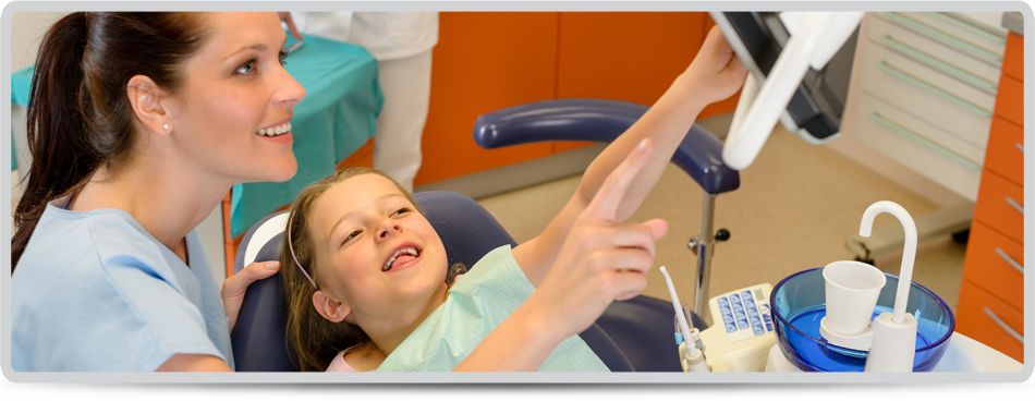 Smiling dentist and child pointing at the screen stomatology office 